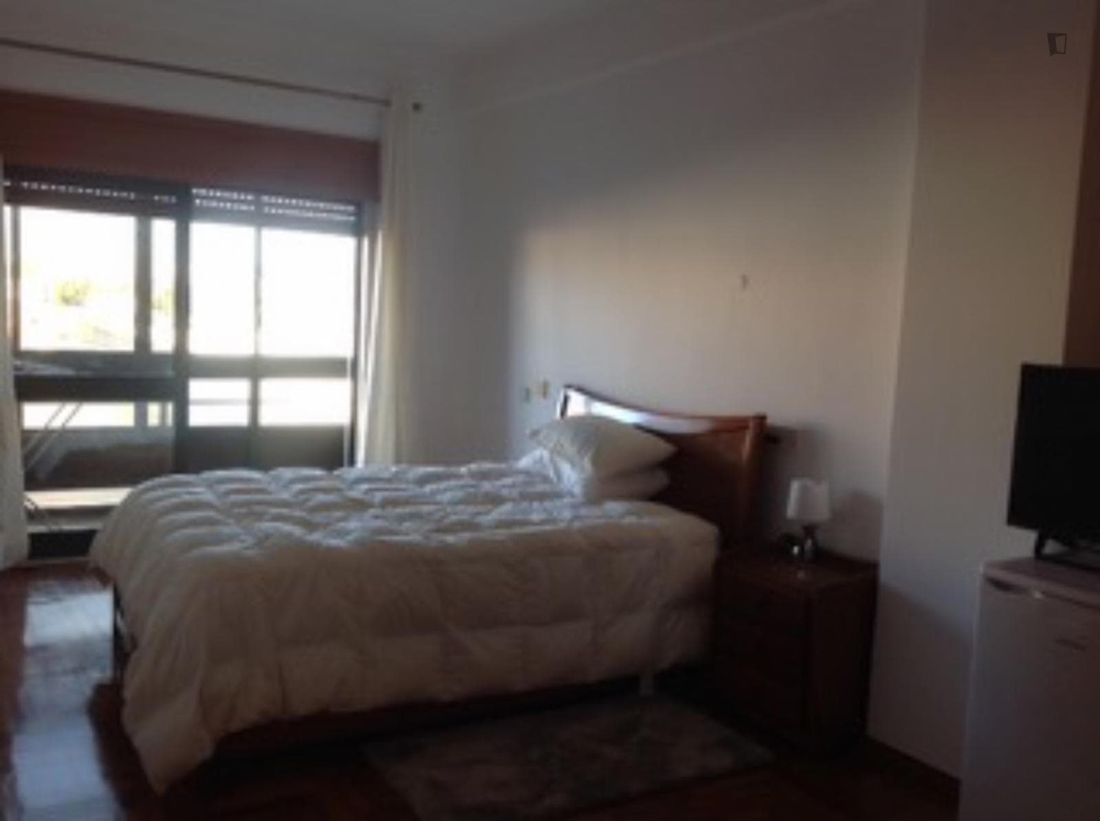 Furnished bedroom with private balcony photo 1